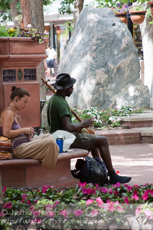 A musician plays on the Pearl Street Mall in Boulder, CO